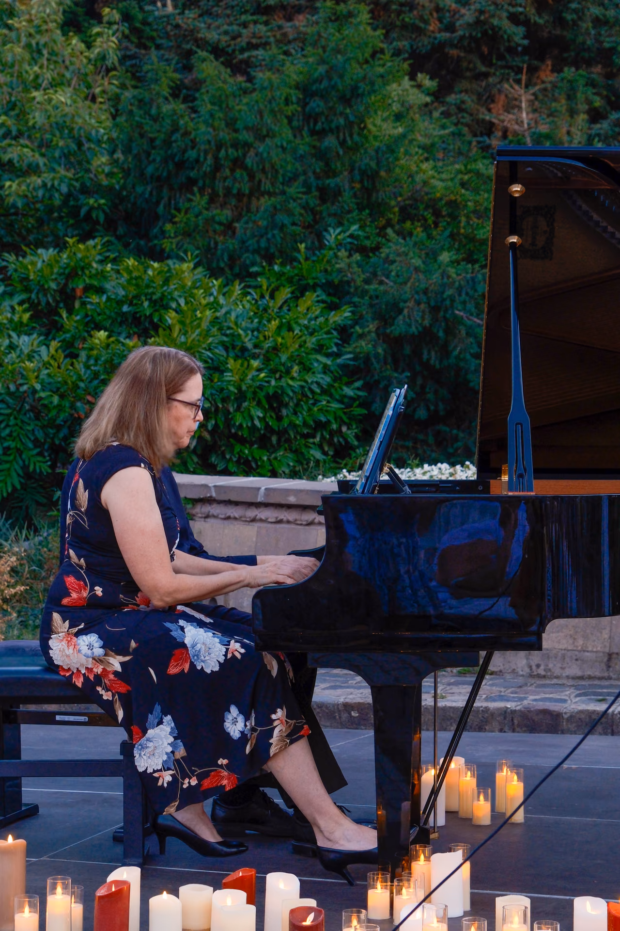 Soloist performing by candlelight at the outdoor concert, Miskolc