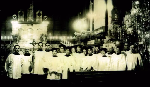 Clergy and choir vested before the decorated altar at Christmas